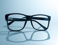 Black Framed Glasses on Reflective Surface Royalty Free Stock Photo