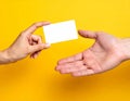 Handing Over a Blank Card on Yellow Royalty Free Stock Photo