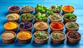Many different herbs in bowls on blue wooden table Royalty Free Stock Photo