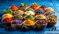 Many different herbs in bowls on blue wooden table Royalty Free Stock Photo