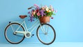 A bicycle with a basket of beautiful flowers on a light blue background. Royalty Free Stock Photo