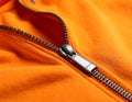 Orange sweatshirt with zipper as background, closeup view Royalty Free Stock Photo
