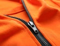 Orange sweatshirt with zipper as background, closeup view Royalty Free Stock Photo