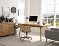 Room interior with comfortable workplace. Modern computer on wooden desk Royalty Free Stock Photo