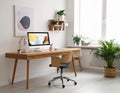 Room interior with comfortable workplace. Modern computer on wooden desk Royalty Free Stock Photo
