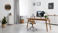 Room interior with comfortable workplace. Modern computer on wooden desk Royalty Free Stock Photo