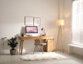 Room interior with comfortable workplace. Modern computer on wooden desk Royalty Free Stock Photo