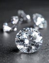 Beautiful shiny diamonds on dark gray table, closeup Royalty Free Stock Photo