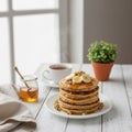 Stack of pancakes topped with banana slices and walnuts sits on a white plate. Royalty Free Stock Photo