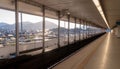 Modern Elevated Train Platform with Cityscape and Mountain View at Sunrise Royalty Free Stock Photo