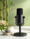Podcast microphone in a zen nature setting with bamboo and stones. Calm audio recording concept for ASMR and wellness. Royalty Free Stock Photo