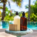 Two bottles of shampoo and handmade soap on old small vintage painted table near Royalty Free Stock Photo