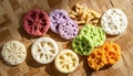 Colorful Thai Krong Krang snacks arranged on a woven mat Royalty Free Stock Photo