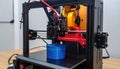 3D Printer Creating a Blue Cylinder Royalty Free Stock Photo