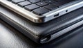 Close-up of a sleek laptop keyboard resting on a textured black leather surface. Royalty Free Stock Photo