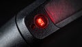 Close-up of a Red Mute Button Indicator Light Royalty Free Stock Photo