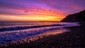 Dramatic Purple and Orange Sunset Over a Pebble Beach Royalty Free Stock Photo