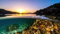 Split view of a sunset over a serene coastline, showing both the sky and underwater world, generated Royalty Free Stock Photo