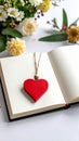 Red wooden heart pendant, an open diary with clean pages and flowers. Romantic concept Royalty Free Stock Photo
