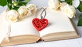 Red wooden heart pendant, an open diary with clean pages and flowers. Romantic concept Royalty Free Stock Photo