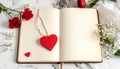 Red wooden heart pendant, an open diary with clean pages and flowers. Romantic concept Royalty Free Stock Photo