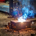 Metal welding with hot sparks and smoke in an industrial workshop. Heavy industry fabrication process. Royalty Free Stock Photo