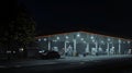 Nighttime Gas Station with Pump Islands and Car at Night, Liminal Royalty Free Stock Photo