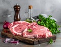 Raw meat on the kitchen table on a metallic background in a composition with cooking Royalty Free Stock Photo