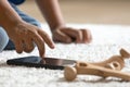 Child\'s Hands Touching Smartphone Beside Wooden Toy on Soft Carpet, Kids and Digital Lifestyle Concept â AI-Generated Royalty Free Stock Photo