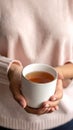 Girl in a sweater holding a mug of hot tea Royalty Free Stock Photo