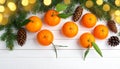 Fresh tangerines, fir branches and cones on a white wooden table, flat. Bokeh lights Royalty Free Stock Photo