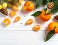 Fresh tangerines, fir branches and cones on a white wooden table, flat. Bokeh lights Royalty Free Stock Photo
