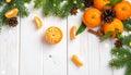 Fresh tangerines, fir branches and cones on a white wooden table, flat. Bokeh lights Royalty Free Stock Photo