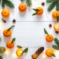 Fresh tangerines, fir branches and cones on a white wooden table, flat. Bokeh lights Royalty Free Stock Photo