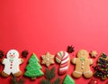 Different tasty Christmas cookies on red background, flat lay. Space for text Royalty Free Stock Photo