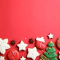 Different tasty Christmas cookies on red background, flat lay. Space for text Royalty Free Stock Photo