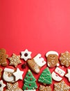 Different tasty Christmas cookies on red background, flat lay. Space for text Royalty Free Stock Photo