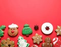 Different tasty Christmas cookies on red background, flat lay. Space for text Royalty Free Stock Photo