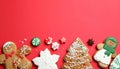 Different tasty Christmas cookies on red background, flat lay. Space for text Royalty Free Stock Photo