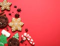 Different tasty Christmas cookies on red background, flat lay. Space for text Royalty Free Stock Photo