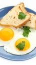 Tasty fried eggs with bread and parsley isolated on white Royalty Free Stock Photo