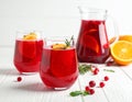Glasses and jug of Red Sangria on white wooden table Royalty Free Stock Photo