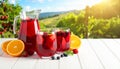Glasses and jug of Red Sangria on white wooden table Royalty Free Stock Photo