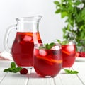 Glasses and jug of Red Sangria on white wooden table Royalty Free Stock Photo