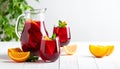 Glasses and jug of Red Sangria on white wooden table Royalty Free Stock Photo