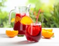 Glasses and jug of Red Sangria on white wooden table Royalty Free Stock Photo