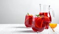 Glasses and jug of Red Sangria on white wooden table Royalty Free Stock Photo
