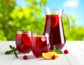 Glasses and jug of Red Sangria on white wooden table Royalty Free Stock Photo
