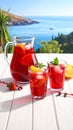 Glasses and jug of Red Sangria on white wooden table Royalty Free Stock Photo