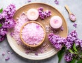 Sea salt spa set with pink lilac flowers. Top view Royalty Free Stock Photo